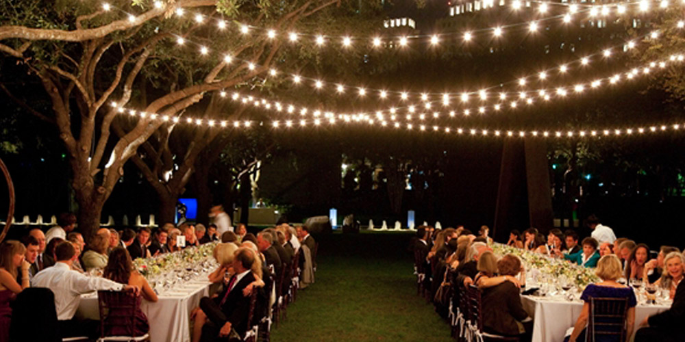 Outdoor reception with festive string lighting